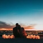 A couple watching the sunrise over Haleakalā volcano in Maui, Hawaii, during their honeymoon.