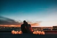 A couple watching the sunrise over Haleakalā volcano in Maui, Hawaii, during their honeymoon.