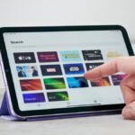 Dive In: Apple's First Water-Resistant iPad Mini Set to Make a Splash 8 A sleek, redesigned Apple iPad mini, possibly submerged slightly in water, showcasing its new water-resistant capabilities.