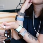 A collection of advanced wearable health technology devices, including smartwatches, rings, and scales, laid out for review.