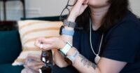 A collection of advanced wearable health technology devices, including smartwatches, rings, and scales, laid out for review.