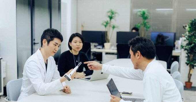 A compact, camera-equipped medical device (Nodoca) used for AI-powered throat examinations.
