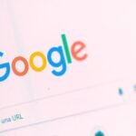 A stylized representation of Google's AI Overviews, showing an AI-generated answer box with embedded links and a magnifying glass icon, symbolizing the future of search.