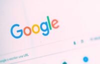 A stylized representation of Google's AI Overviews, showing an AI-generated answer box with embedded links and a magnifying glass icon, symbolizing the future of search.