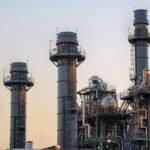Amazon's Green Paradox: Texas Data Center Poised to Become Nation's Largest Climate Polluter 8 Illustration of a large data center with smoke stacks emitting carbon dioxide, symbolizing climate pollution.