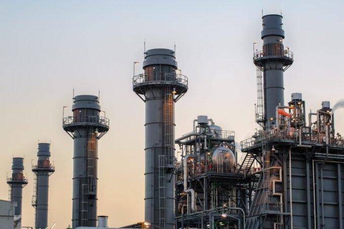 Illustration of a large data center with smoke stacks emitting carbon dioxide, symbolizing climate pollution.