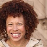 Angela Nissel: Finding Laughter in Loss and Unpacking a Digital Legacy 8 Angela Nissel smiles, a thoughtful expression on her face, in a professional portrait.