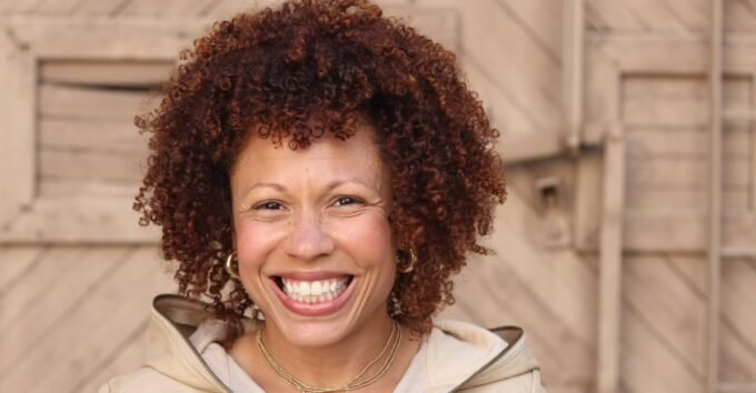 Angela Nissel: Finding Laughter in Loss and Unpacking a Digital Legacy 9 Angela Nissel smiles, a thoughtful expression on her face, in a professional portrait.