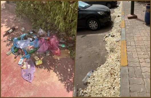 صورة لمجمع سكني يعاني من الإهمال في النظافة وصيانة المساحات الخضراء، مع وجود كاميرات مراقبة مثيرة للجدل.