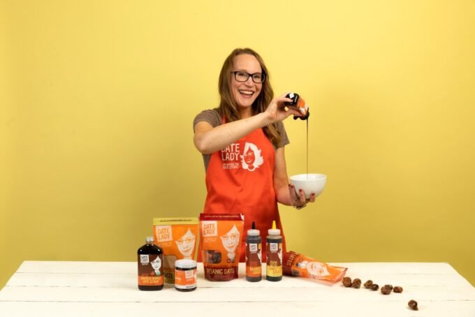 Colleen Sundlie, founder of Date Lady, smiling with her organic date products.