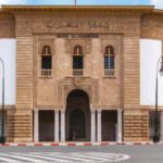 Une pile de dirhams marocains, symbolisant l'augmentation du cash en circulation, avec en arrière-plan des éléments suggérant la digitalisation des paiements, comme une carte bancaire ou un smartphone.