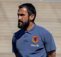Adil Ramzi, l'ancien international marocain et nouvel entraîneur adjoint de la sélection des Pays-Bas, posant avec un sourire confiant.