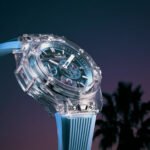 Hublot Big Bang Sapphire Sky Blue watch with a clear sapphire case, sky-blue skeletonized dial, and matching rubber strap, showcasing its intricate Meca-10 movement.