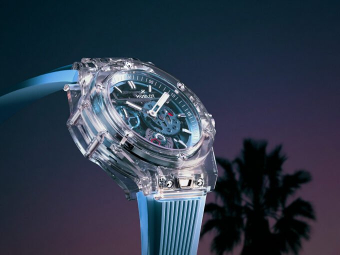 Hublot Big Bang Sapphire Sky Blue watch with a clear sapphire case, sky-blue skeletonized dial, and matching rubber strap, showcasing its intricate Meca-10 movement.