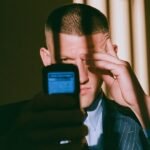 A person looking distressed while holding financial documents, symbolizing investment scam losses and the path to recovery.