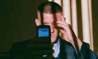 A person looking distressed while holding financial documents, symbolizing investment scam losses and the path to recovery.