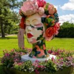 Colorful monumental sculptures by Ken Kelleher installed amidst the lush gardens of the Royal Botanical Gardens, with visitors interacting with the art.