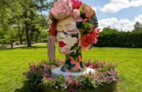 Colorful monumental sculptures by Ken Kelleher installed amidst the lush gardens of the Royal Botanical Gardens, with visitors interacting with the art.