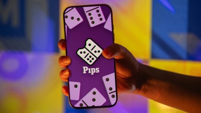 A screenshot of the NYT Pips game board showing various color-coded domino tiles and conditions.