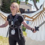 Laura Mathews showcasing impressive mechanical wings at Open Sauce