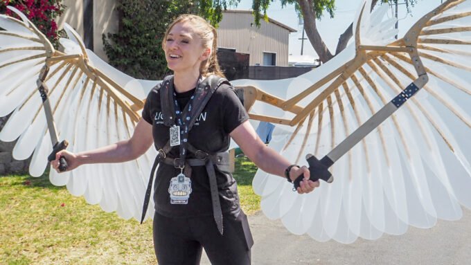 Laura Mathews showcasing impressive mechanical wings at Open Sauce