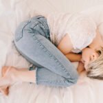 Woman experiencing a hot flash, symbolizing the long-term impact of perinatal depression on menopausal symptoms.