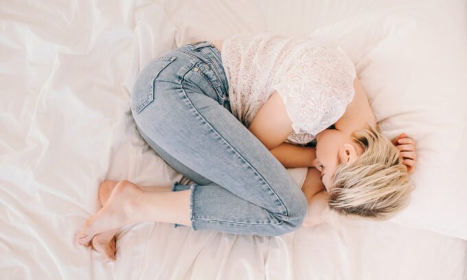 Woman experiencing a hot flash, symbolizing the long-term impact of perinatal depression on menopausal symptoms.