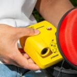 A collection of Polaroid instant cameras featuring Pikachu, Sylveon, and Poké Ball designs, along with themed film and accessories.
