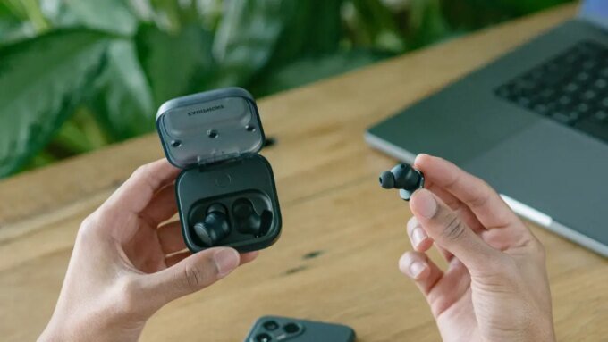 A collection of wireless earbuds, some with their battery compartments open, symbolizing repairability.