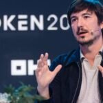 Robinhood Secures UK Crypto Foothold Ahead of Landmark Regulatory Shift 6 Robinhood CEO Vlad Tenev speaking at a crypto conference, symbolizing the company's expansion into new markets.