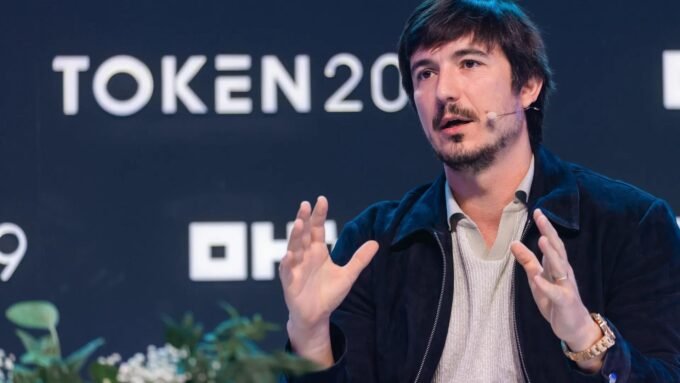 Robinhood Secures UK Crypto Foothold Ahead of Landmark Regulatory Shift 9 Robinhood CEO Vlad Tenev speaking at a crypto conference, symbolizing the company's expansion into new markets.