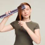 The Shark FlexStyle IonCurl: Elevating Hair Styling Through Ingenious Redesign 8 Shark FlexStyle IonCurl hair styling tool in Lilac and Strawberry Matcha colors, showcasing its sleek design and various attachments.