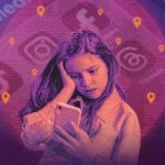 A child's hand holding a smartphone, with social media app icons blurred in the background, symbolizing restrictions and online safety.