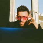 A solo entrepreneur efficiently managing multiple social media platforms from a single dashboard, symbolizing streamlined digital marketing and productivity.
