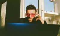 A solo entrepreneur efficiently managing multiple social media platforms from a single dashboard, symbolizing streamlined digital marketing and productivity.