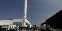 SpaceX Starship rocket launch with a backdrop of a power plant, symbolizing energy needs