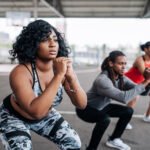 Unlock Pain-Free Squats: The Simple Heel Elevation Tweak for Lower Back Relief 8 Person performing a squat with elevated heels, demonstrating proper form to reduce lower back stress.