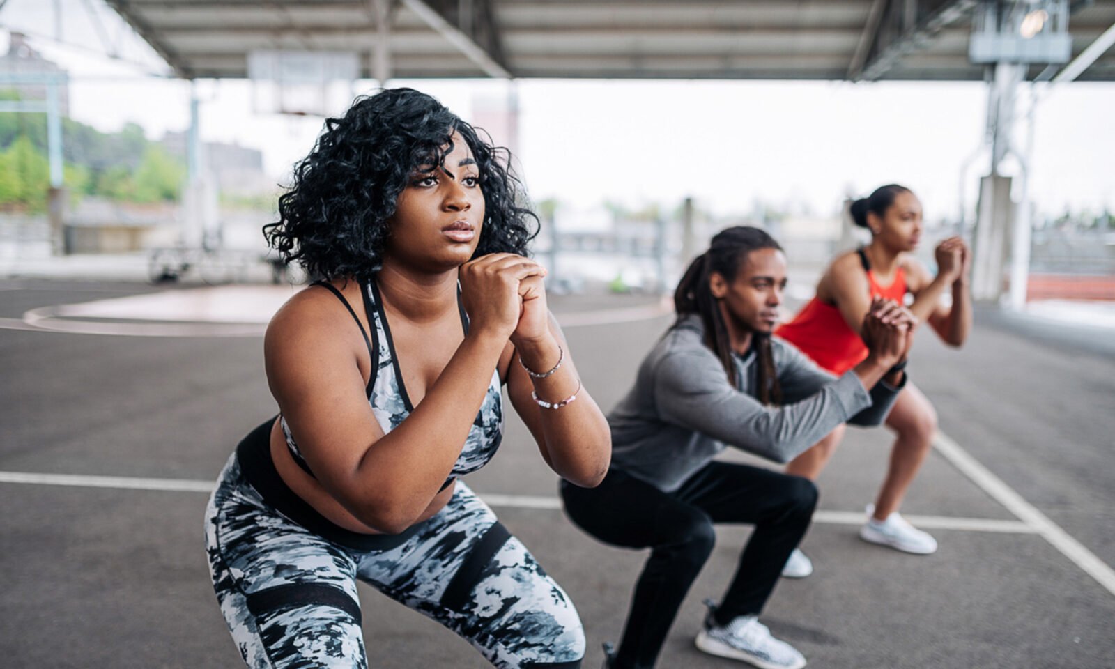 Person performing a squat with elevated heels, demonstrating proper form to reduce lower back stress.
