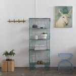 Eco-Chic Living: 6 Sustainable Furnishings to Transform Your Home 8 A collection of stylish and sustainable home furnishings, including a modern vase, an outdoor solar lamp, and a wooden bed frame.