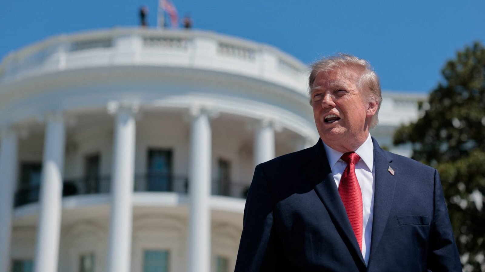 President Donald Trump speaking at the White House, discussing financial transactions and his investment portfolio.