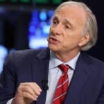 Dalio's Dire Warning: US Debt Crisis Looms, Gold and Bitcoin Recommended 6 Ray Dalio speaking at the New York Stock Exchange, discussing economic forecasts and investment strategies.