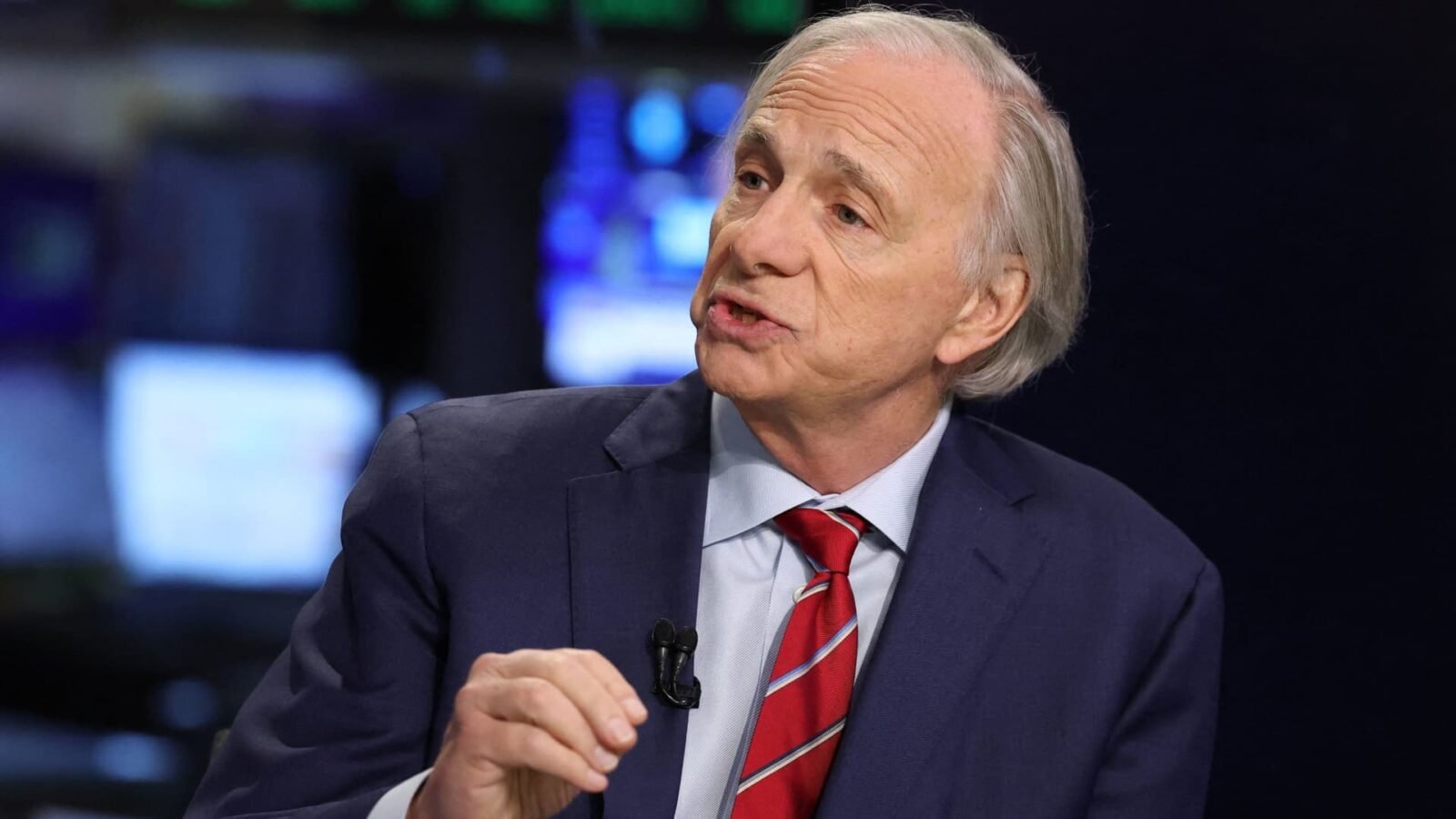 Ray Dalio speaking at the New York Stock Exchange, discussing economic forecasts and investment strategies.