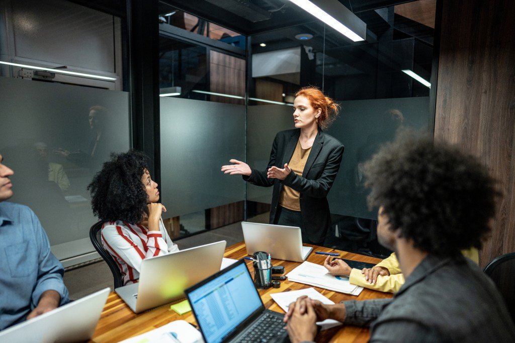 A founder contemplating data and AI-generated insights, symbolizing the shift from execution to judgment in the age of artificial intelligence.