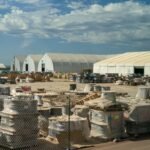 AI's Trillion-Dollar Dilemma: Soaring Debt Costs Cast a Shadow on Infrastructure Expansion 6 Electrical wires outside Stargate AI data center, a collaboration of OpenAI, Oracle, and SoftBank, symbolizing AI infrastructure buildout.