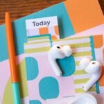 A pair of Apple AirPods Pro earbuds, representing the potential future of wearable tech with integrated cameras.