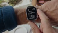 Close-up of an Apple Watch displaying a text summary, symbolizing the new Audio Intelligence features.