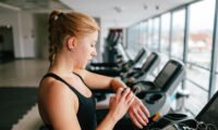 A person with asthma engaging in light everyday physical activity, such as walking or taking stairs, symbolizing accessible exercise.