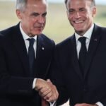 Canadian Prime Minister Mark Carney and French President Emmanuel Macron shake hands at a bilateral meeting.