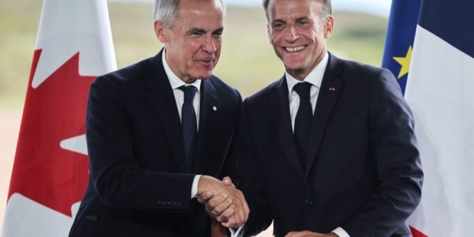 Canadian Prime Minister Mark Carney and French President Emmanuel Macron shake hands at a bilateral meeting.