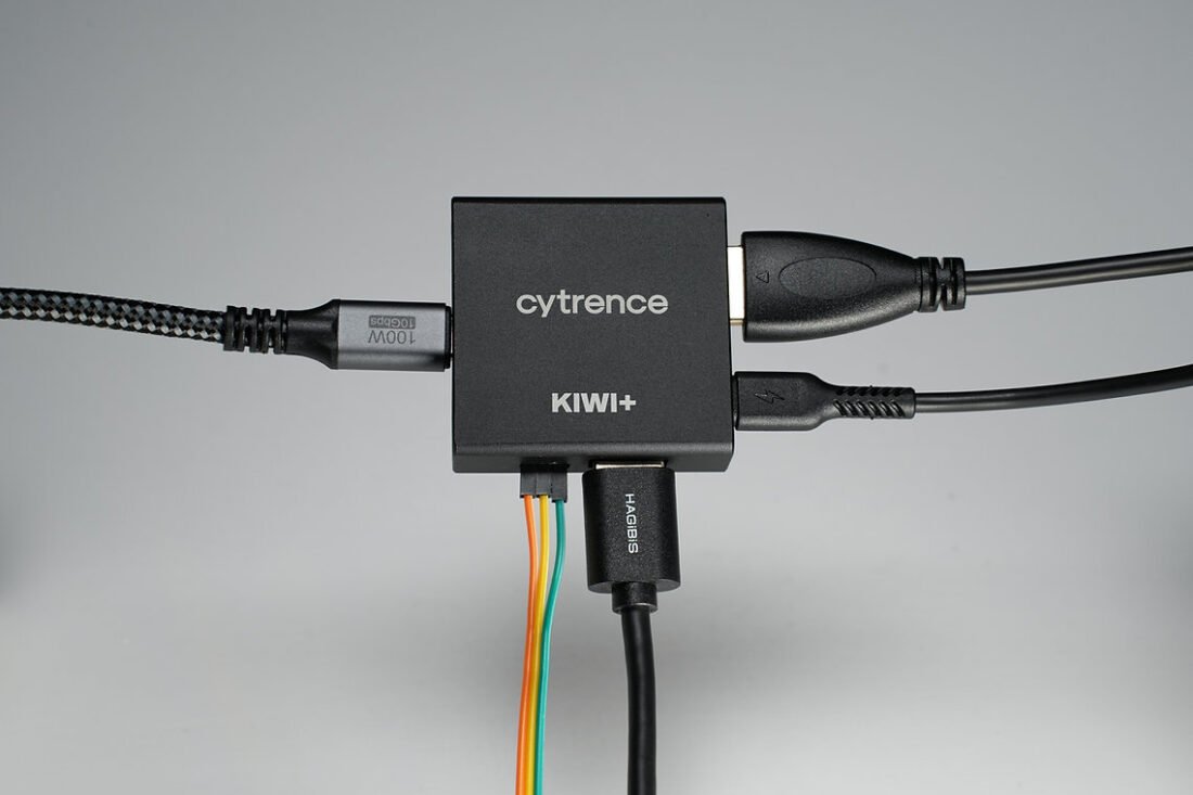 Cytrence Kiwi+ device connected to a Raspberry Pi and a laptop, demonstrating its KVM functionality.